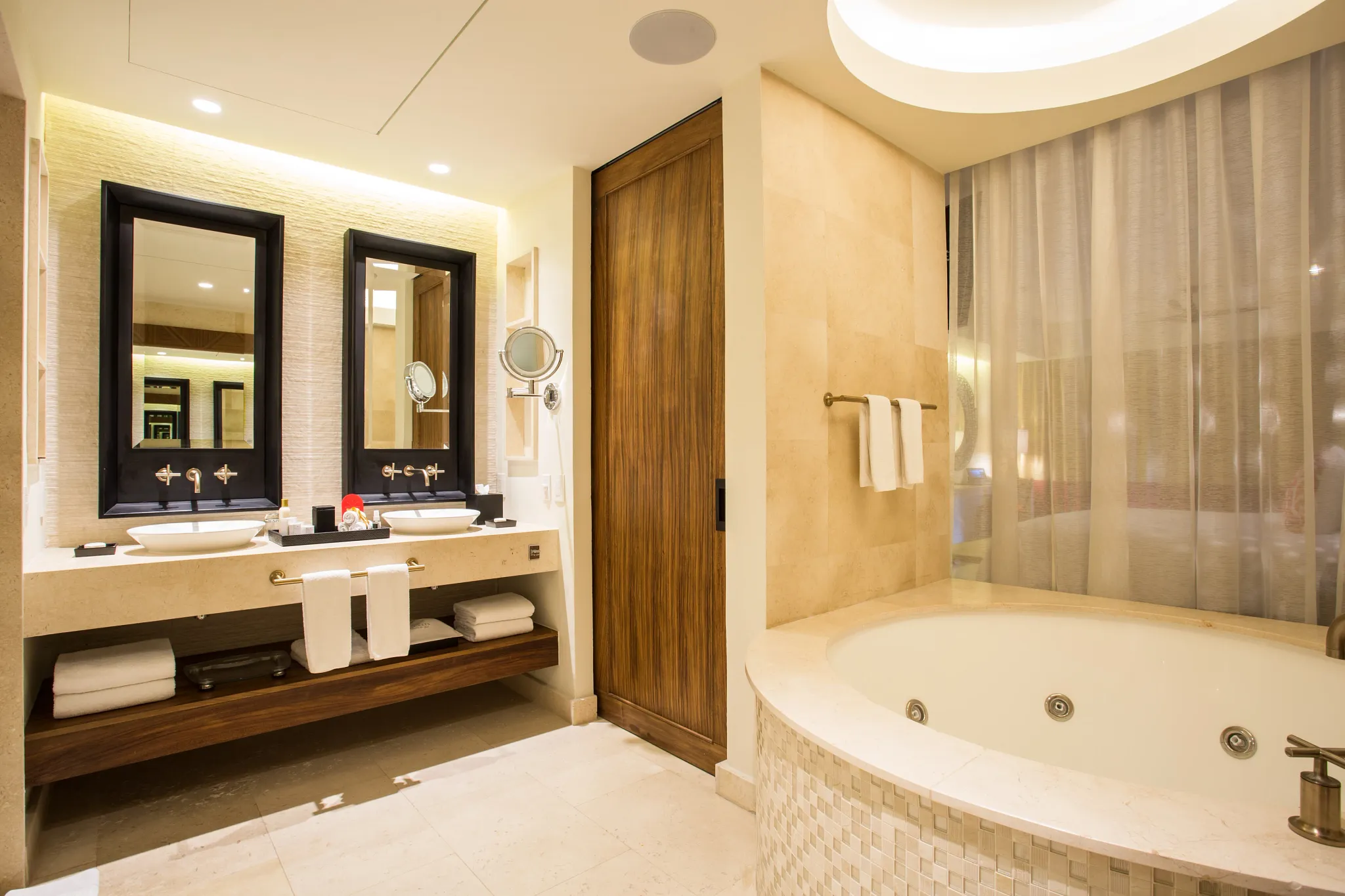 Junior Suite bathroom with double sinks and in-room hot tub at Secrets Akumal Riviera Maya.