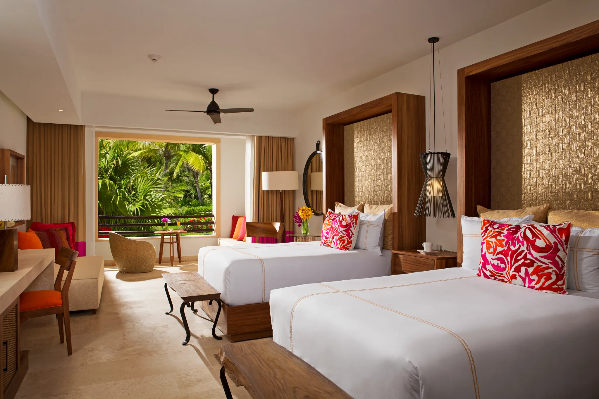 Junior Suite with two double beds and resort view balcony at Secrets Akumal Riviera Maya.